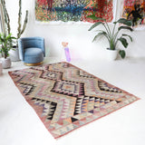 Vintage kilim rug in living room setting, old rug, antique rug, pastel colors, faded colors, Turkish rug, vintage rug, soft rug, Portland, Oregon, rug store, rug shop, local shop, earthy tones, earthy colors, warm colors