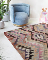 Vintage kilim rug in living room setting, old rug, antique rug, pastel colors, faded colors, Turkish rug, vintage rug, soft rug, Portland, Oregon, rug store, rug shop, local shop, earthy tones, earthy colors, warm colors