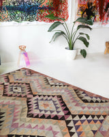 Vintage kilim rug in living room setting, old rug, antique rug, pastel colors, faded colors, Turkish rug, vintage rug, soft rug, Portland, Oregon, rug store, rug shop, local shop, earthy tones, earthy colors, warm colors
