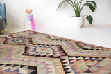 Vintage kilim rug in living room setting, old rug, antique rug, pastel colors, faded colors, Turkish rug, vintage rug, soft rug, Portland, Oregon, rug store, rug shop, local shop, earthy tones, earthy colors, warm colors