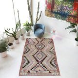 Vintage kilim rug in living room setting, old rug, antique rug, pastel colors, faded colors, Turkish rug, vintage rug, soft rug, Portland, Oregon, rug store, rug shop, local shop, earthy tones, earthy colors, warm colors