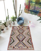 Vintage kilim rug in living room setting, old rug, antique rug, pastel colors, faded colors, Turkish rug, vintage rug, soft rug, Portland, Oregon, rug store, rug shop, local shop, earthy tones, earthy colors, warm colors