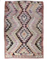 Vintage kilim rug in living room setting, old rug, antique rug, pastel colors, faded colors, Turkish rug, vintage rug, soft rug, Portland, Oregon, rug store, rug shop, local shop, earthy tones, earthy colors, warm colors