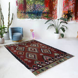 Vintage kilim rug in living room setting, bright colors, wild shaman, soft rug, bold color, Portland, Oregon, rug store, rug shop, local shop, vintage rug, modern kilim, warm colors, antique rug, antique kilim