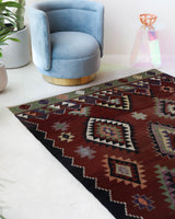 Vintage kilim rug in living room setting, bright colors, wild shaman, soft rug, bold color, Portland, Oregon, rug store, rug shop, local shop, vintage rug, modern kilim, warm colors, antique rug, antique kilim