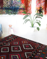 Vintage kilim rug in living room setting, bright colors, wild shaman, soft rug, bold color, Portland, Oregon, rug store, rug shop, local shop, vintage rug, modern kilim, warm colors, antique rug, antique kilim