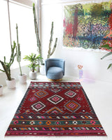 Vintage kilim rug in living room setting, bright colors, wild shaman, soft rug, bold color, Portland, Oregon, rug store, rug shop, local shop, vintage rug, modern kilim, warm colors, antique rug, antique kilim