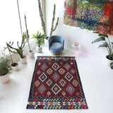 Vintage kilim rug in living room setting, bright colors, wild shaman, soft rug, bold color, Portland, Oregon, rug store, rug shop, local shop, vintage rug, modern kilim, warm colors, antique rug, antique kilim