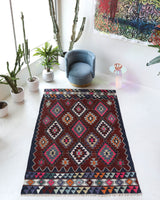 Vintage kilim rug in living room setting, bright colors, wild shaman, soft rug, bold color, Portland, Oregon, rug store, rug shop, local shop, vintage rug, modern kilim, warm colors, antique rug, antique kilim