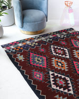 Vintage kilim rug in living room setting, bright colors, wild shaman, soft rug, bold color, Portland, Oregon, rug store, rug shop, local shop, vintage rug, modern kilim, warm colors, antique rug, antique kilim