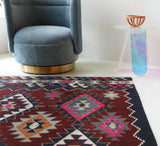 Vintage kilim rug in living room setting, bright colors, wild shaman, soft rug, bold color, Portland, Oregon, rug store, rug shop, local shop, vintage rug, modern kilim, warm colors, antique rug, antique kilim