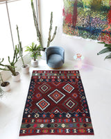 Vintage kilim rug in living room setting, bright colors, wild shaman, soft rug, bold color, Portland, Oregon, rug store, rug shop, local shop, vintage rug, modern kilim, warm colors, antique rug, antique kilim