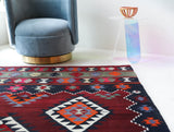 Vintage kilim rug in living room setting, bright colors, wild shaman, soft rug, bold color, Portland, Oregon, rug store, rug shop, local shop, vintage rug, modern kilim, warm colors, antique rug, antique kilim