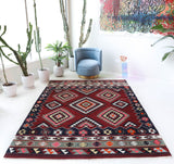 Vintage kilim rug in living room setting, bright colors, wild shaman, soft rug, bold color, Portland, Oregon, rug store, rug shop, local shop, vintage rug, modern kilim, warm colors, antique rug, antique kilim