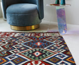 Vintage kilim rug in living room setting, bright colors, wild shaman, soft rug, bold color, Portland, Oregon, rug store, rug shop, local shop, vintage rug, modern kilim, warm colors, antique rug, antique kilim