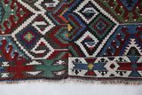 Vintage kilim rug in living room setting, bright colors, wild shaman, soft rug, bold color, Portland, Oregon, rug store, rug shop, local shop, vintage rug, modern kilim, warm colors, antique rug, antique kilim
