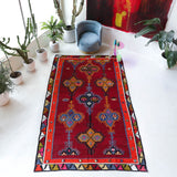 Vintage kilim rug in living room setting, bright colors, wild shaman, soft rug, bold color, Portland, Oregon, rug store, rug shop, local shop, vintage rug, modern kilim, warm colors, antique rug, antique kilim