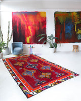 Vintage kilim rug in living room setting, bright colors, wild shaman, soft rug, bold color, Portland, Oregon, rug store, rug shop, local shop, vintage rug, modern kilim, warm colors, antique rug, antique kilim