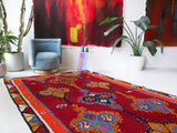 Vintage kilim rug in living room setting, bright colors, wild shaman, soft rug, bold color, Portland, Oregon, rug store, rug shop, local shop, vintage rug, modern kilim, warm colors, antique rug, antique kilim