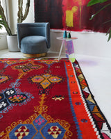 Vintage kilim rug in living room setting, bright colors, wild shaman, soft rug, bold color, Portland, Oregon, rug store, rug shop, local shop, vintage rug, modern kilim, warm colors, antique rug, antique kilim