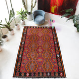 Vintage kilim rug in living room setting, bright colors, wild shaman, soft rug, bold color, Portland, Oregon, rug store, rug shop, local shop, vintage rug, modern kilim, warm colors, antique rug, antique kilim