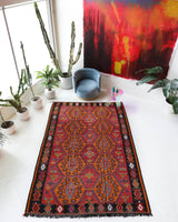 Vintage kilim rug in living room setting, bright colors, wild shaman, soft rug, bold color, Portland, Oregon, rug store, rug shop, local shop, vintage rug, modern kilim, warm colors, antique rug, antique kilim