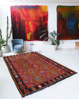 Vintage kilim rug in living room setting, bright colors, wild shaman, soft rug, bold color, Portland, Oregon, rug store, rug shop, local shop, vintage rug, modern kilim, warm colors, antique rug, antique kilim