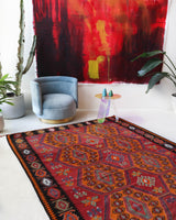 Vintage kilim rug in living room setting, bright colors, wild shaman, soft rug, bold color, Portland, Oregon, rug store, rug shop, local shop, vintage rug, modern kilim, warm colors, antique rug, antique kilim