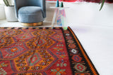 Vintage kilim rug in living room setting, bright colors, wild shaman, soft rug, bold color, Portland, Oregon, rug store, rug shop, local shop, vintage rug, modern kilim, warm colors, antique rug, antique kilim