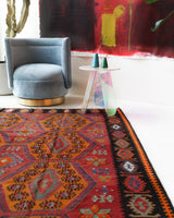 Vintage kilim rug in living room setting, bright colors, wild shaman, soft rug, bold color, Portland, Oregon, rug store, rug shop, local shop, vintage rug, modern kilim, warm colors, antique rug, antique kilim