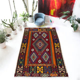 Vintage kilim rug in living room setting, bright colors, wild shaman, soft rug, bold color, Portland, Oregon, rug store, rug shop, local shop, vintage rug, modern kilim, warm colors, antique rug, antique kilim