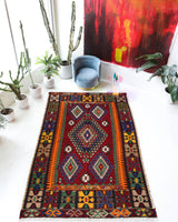 Vintage kilim rug in living room setting, bright colors, wild shaman, soft rug, bold color, Portland, Oregon, rug store, rug shop, local shop, vintage rug, modern kilim, warm colors, antique rug, antique kilim