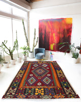 Vintage kilim rug in living room setting, bright colors, wild shaman, soft rug, bold color, Portland, Oregon, rug store, rug shop, local shop, vintage rug, modern kilim, warm colors, antique rug, antique kilim