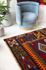 Vintage kilim rug in living room setting, bright colors, wild shaman, soft rug, bold color, Portland, Oregon, rug store, rug shop, local shop, vintage rug, modern kilim, warm colors, antique rug, antique kilim