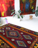 Vintage kilim rug in living room setting, bright colors, wild shaman, soft rug, bold color, Portland, Oregon, rug store, rug shop, local shop, vintage rug, modern kilim, warm colors, antique rug, antique kilim
