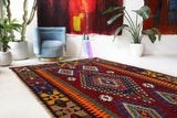 Vintage kilim rug in living room setting, bright colors, wild shaman, soft rug, bold color, Portland, Oregon, rug store, rug shop, local shop, vintage rug, modern kilim, warm colors, antique rug, antique kilim