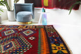 Vintage kilim rug in living room setting, bright colors, wild shaman, soft rug, bold color, Portland, Oregon, rug store, rug shop, local shop, vintage rug, modern kilim, warm colors, antique rug, antique kilim