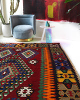 Vintage kilim rug in living room setting, bright colors, wild shaman, soft rug, bold color, Portland, Oregon, rug store, rug shop, local shop, vintage rug, modern kilim, warm colors, antique rug, antique kilim