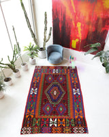 Vintage kilim rug in living room setting, bright colors, wild shaman, soft rug, bold color, Portland, Oregon, rug store, rug shop, local shop, vintage rug, modern kilim, warm colors, antique rug, antique kilim
