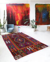 Vintage kilim rug in living room setting, bright colors, wild shaman, soft rug, bold color, Portland, Oregon, rug store, rug shop, local shop, vintage rug, modern kilim, warm colors, antique rug, antique kilim