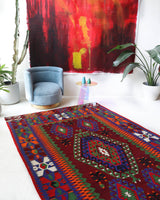 Vintage kilim rug in living room setting, bright colors, wild shaman, soft rug, bold color, Portland, Oregon, rug store, rug shop, local shop, vintage rug, modern kilim, warm colors, antique rug, antique kilim