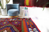 Vintage kilim rug in living room setting, bright colors, wild shaman, soft rug, bold color, Portland, Oregon, rug store, rug shop, local shop, vintage rug, modern kilim, warm colors, antique rug, antique kilim