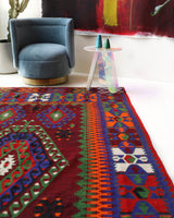 Vintage kilim rug in living room setting, bright colors, wild shaman, soft rug, bold color, Portland, Oregon, rug store, rug shop, local shop, vintage rug, modern kilim, warm colors, antique rug, antique kilim