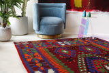 Vintage kilim rug in living room setting, bright colors, wild shaman, soft rug, bold color, Portland, Oregon, rug store, rug shop, local shop, vintage rug, modern kilim, warm colors, antique rug, antique kilim