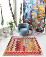 Vintage kilim rug in living room setting, old rug, antique rug, pastel colors, faded colors, Turkish rug, vintage rug, soft rug, Portland, Oregon, rug store, rug shop, local shop, earthy tones, earthy colors, warm colors