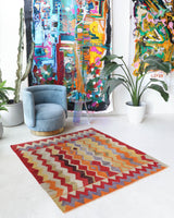 Vintage kilim rug in living room setting, old rug, antique rug, pastel colors, faded colors, Turkish rug, vintage rug, soft rug, Portland, Oregon, rug store, rug shop, local shop, earthy tones, earthy colors, warm colors