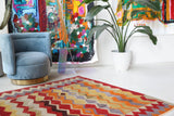 Vintage kilim rug in living room setting, old rug, antique rug, pastel colors, faded colors, Turkish rug, vintage rug, soft rug, Portland, Oregon, rug store, rug shop, local shop, earthy tones, earthy colors, warm colors