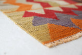 Vintage kilim rug in living room setting, old rug, antique rug, pastel colors, faded colors, Turkish rug, vintage rug, soft rug, Portland, Oregon, rug store, rug shop, local shop, earthy tones, earthy colors, warm colors