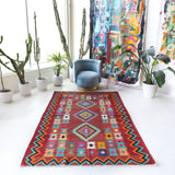 Vintage kilim rug in living room setting, bright colors, wild shaman, soft rug, bold color, Portland, Oregon, rug store, rug shop, local shop, vintage rug, modern kilim, warm colors, antique rug, antique kilim