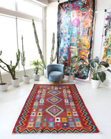 Vintage kilim rug in living room setting, bright colors, wild shaman, soft rug, bold color, Portland, Oregon, rug store, rug shop, local shop, vintage rug, modern kilim, warm colors, antique rug, antique kilim